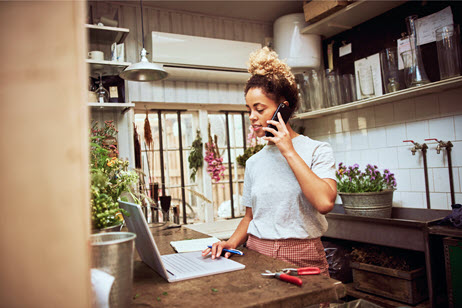 Woman on the phone whilst using laptop