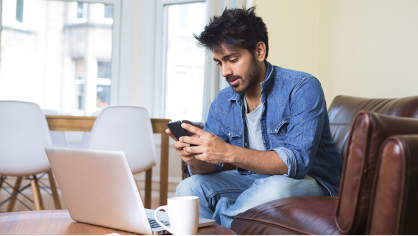 Man on a couch using a phone